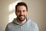 a headshot of a man in comfortable clothes